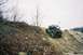1992 Ford Bronco - An off-road buggy navigates a steep, rocky incline under an overcast sky.