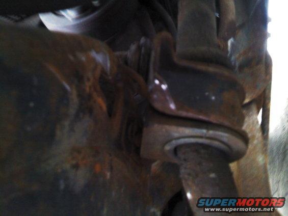 Rusty swaybar bushings and mounting bracket, close-up view