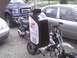2003 Ford Crown Victoria - A creative modification involves attaching a motor oil bottle to a dirt bike, with other vehicles visible.