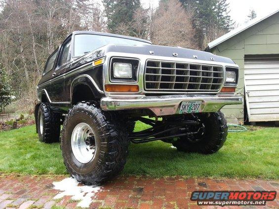 Lifted black Ford Bronco with a large grille and custom plate SKY 207