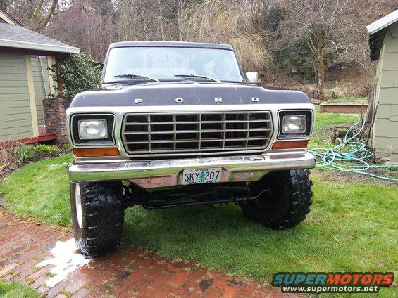 Black 1979 Ford Bronco with lifted suspension and large tires, viewed from the front