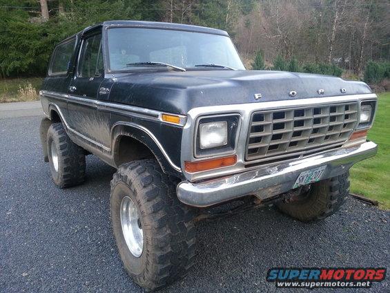 Black Ford Bronco lifted with large off-road tires, front quarter view