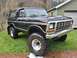 1979 Ford Bronco - This lifted 1979 Ford Bronco features a prominent chrome grille and large off-road tires.