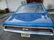 1968 Mercury Cougar - Blue 1968 Mercury Cougar parked in front of a garage, showing its distinctive rear grille and taillights.