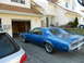 1968 Mercury Cougar - A blue 1969 Mercury Cougar is parked in front of a residential garage.