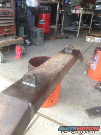 Fabricated steel bumper part with welded brackets on orange buckets