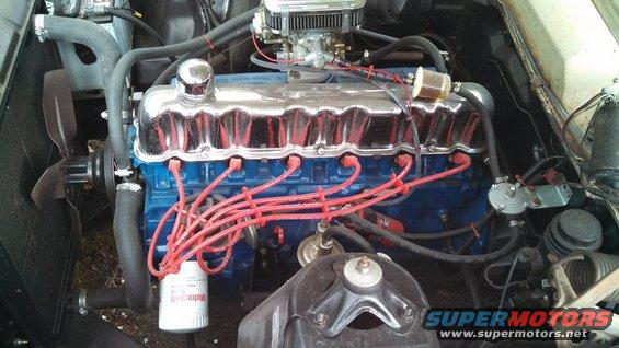 Engine bay with blue block, chrome valve covers, and red spark plug wires
