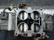 1995 Ford Bronco - This is a close-up view of a carburetor, a critical engine component for fuel delivery.