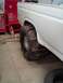 1995 Ford Bronco - White Ford Bronco with oversized mud tires is shown in a garage setting.