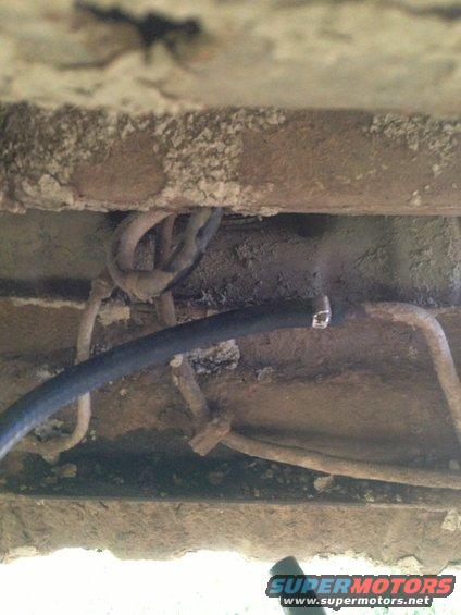 Underbody view of fuel lines and wiring with SuperMotors.net watermark