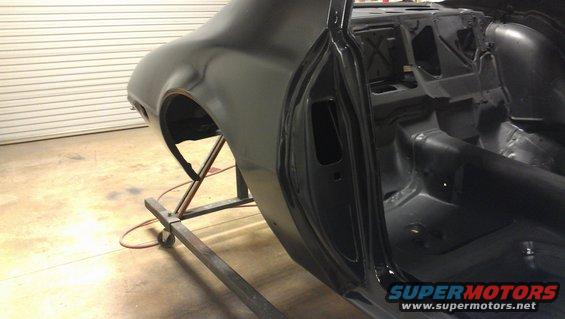 Black 1972 Pontiac Trans Am interior and rear quarter panel during restoration