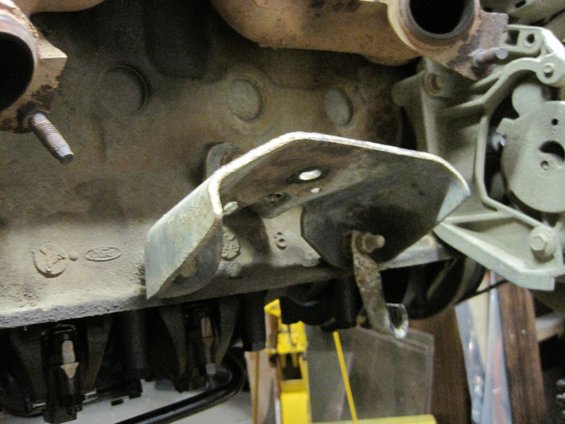 Engine cross member bracket with number 8 stamped on it