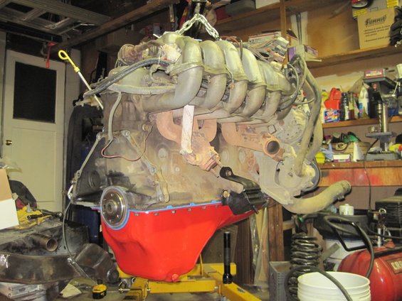 Engine being lifted out of a vehicle, possibly for repair or replacement