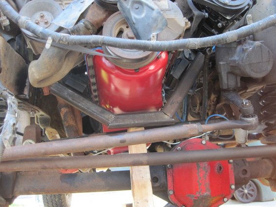 Close-up of an engine bay showing a red component and metal framing