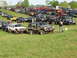 1979 Ford Bronco - A gathering of off-road vehicles, including a Jeep Cherokee, parked on a grassy field.