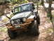 1979 Ford Bronco - This modified Jeep Wrangler tackles a challenging off-road course with mud-caked tires and a bumper.