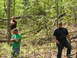 1979 Ford Bronco - Three men are in a wooded area. The man in the foreground wears a black t-shirt and sunglasses.