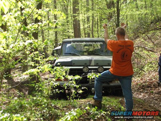 Camouflaged Ford Bronco with "FullsizeBronco.com" sticker on windshield, front view