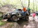 1979 Ford Bronco - This off-road vehicle, likely a 1978 Ford Bronco, is being assisted by onlookers while traversing a rocky trail.