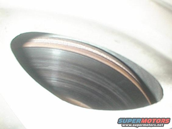 Close-up of a worn brake rotor with visible scoring