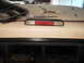 1979 Ford F-150 - Third brake light assembly and trim piece on a surface, possibly a vehicle roof.