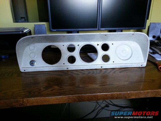 Beige dashboard instrument cluster with multiple gauge cutouts and a keyhole