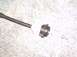 1991 Ford Crown Victoria - This is a close-up view of a clutch cable mechanism, likely a part from a vehicle.