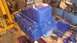 1973 Ford Torino - Engine block painted blue, resting on an engine stand with a toolbox and other parts around it.