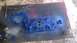 1973 Ford Torino - An intake manifold is being spray painted blue, with tools and cans nearby.