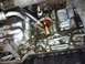1993 Ford Probe - Close-up view of an engine's oil filter housing assembly with attached hoses.