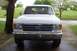 1990 Ford Bronco - This 1990 Ford Bronco is shown from the front, parked on a wet driveway.