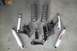 1990 Ford Bronco - Various suspension components, including shocks and springs, are arranged on a flat surface.