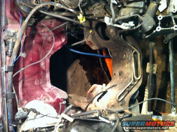 Engine bay with red inner fender and complex metal framework