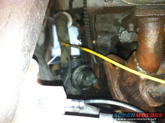 Close-up of engine components with hoses and wiring