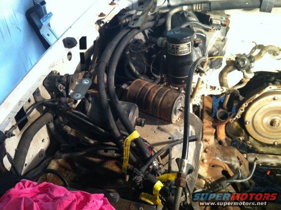 Engine bay with hoses and rusty components