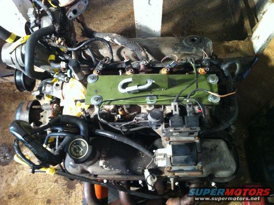 Engine with wiring harnesses and fuel injectors. Oil cap visible