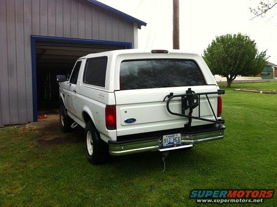 White 1992 Ford Bronco rear view with spare tire carrier and license plate 912 HCX
