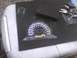2003 Ford Crown Victoria - A car's dashboard gauge cluster is shown with keys and a sanding block nearby.