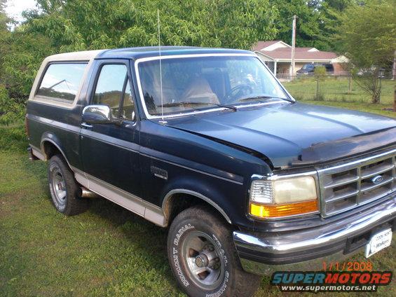 1993 Ford Bronco, dark blue with tan top, 3/4 front view