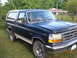 1993 Ford Bronco - This 1993 Ford Bronco is seen from a 3/4 front angle, parked outdoors.