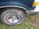 1993 Ford Bronco - Close-up of a 1993 Ford Bronco's front wheel, tire, and fender area.