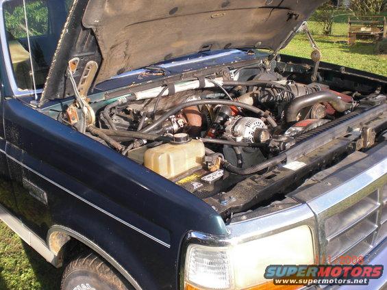 Engine bay of a 1993 Ford Bronco, dark green exterior