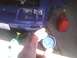 2003 Ford Crown Victoria - A blue car's front end is visible with an oil drain pan and a red gas can nearby.