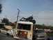 1986 Ford Bronco - A buggy is loaded onto the roof of a van, parked next to other vehicles in a lot.