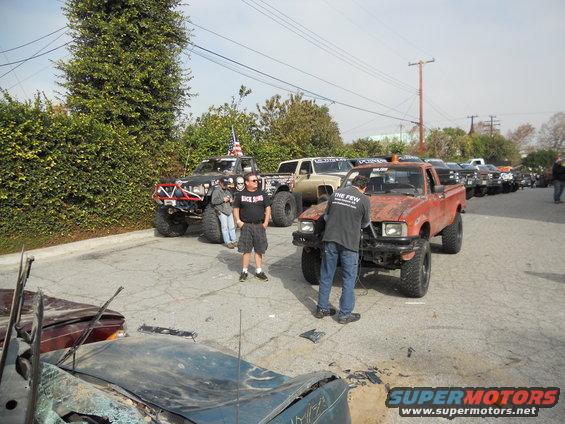 Orange pickup truck with lifted suspension and off-road tires