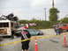 1986 Ford Bronco - A chaotic scene with several damaged vehicles, a bus, and a custom buggy, cordoned off with caution tape.