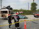1986 Ford Bronco - Several damaged vehicles and a bus are present, with people wearing Santa hats observing the scene.