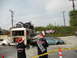 1986 Ford Bronco - A chaotic scene depicts several damaged vehicles, a bus, and people in Santa hats, with caution tape cordoning off the area.