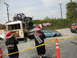 1986 Ford Bronco - A bizarre scene unfolds with multiple damaged vehicles, a bus carrying a buggy, and individuals in festive attire.