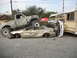 1986 Ford Bronco - Multiple vehicles involved in a severe collision, with one truck crushing a sedan.